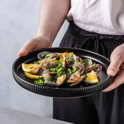 Elegant black porcelain plates with gold rim finish.
