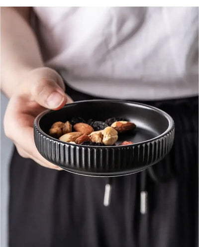Elegant black porcelain plates with gold rim finish.