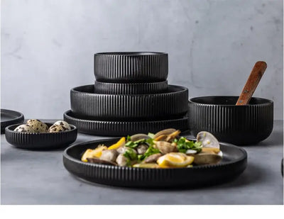 Elegant black porcelain plates with gold rim finish.