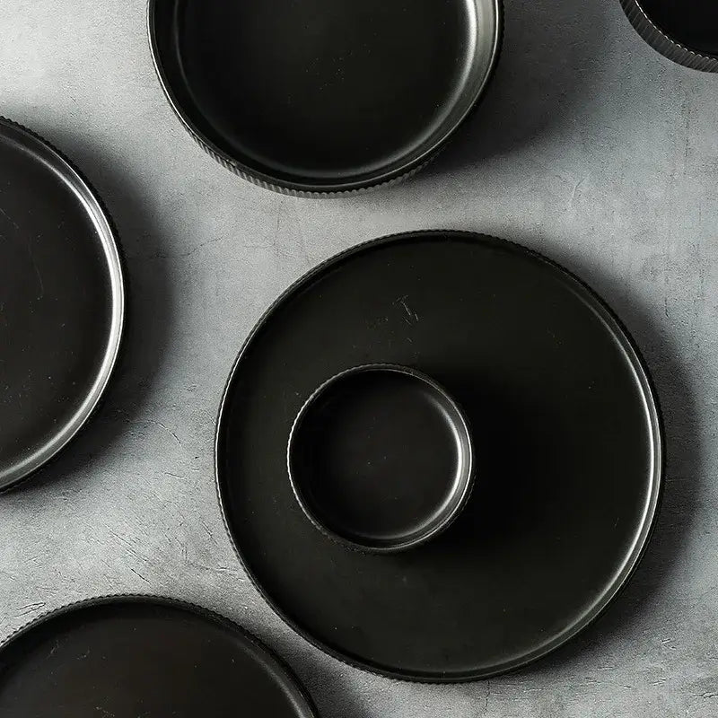 Elegant black porcelain plates with gold rim finish.
