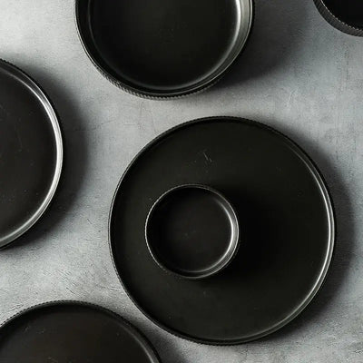 Elegant black porcelain plates with gold rim finish.